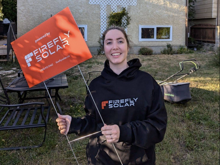 Happy Firefly Solar customer with team member
